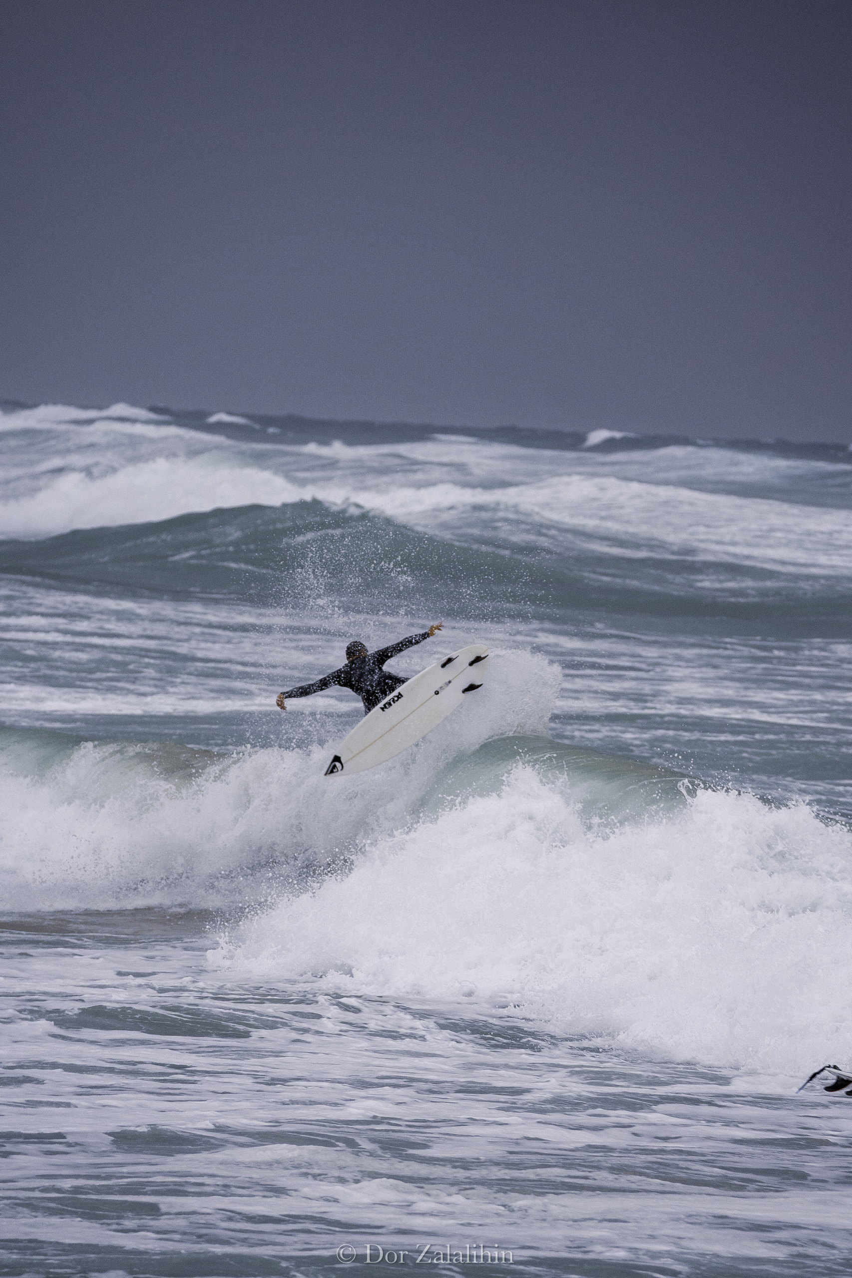 Surfer under heavy storm light