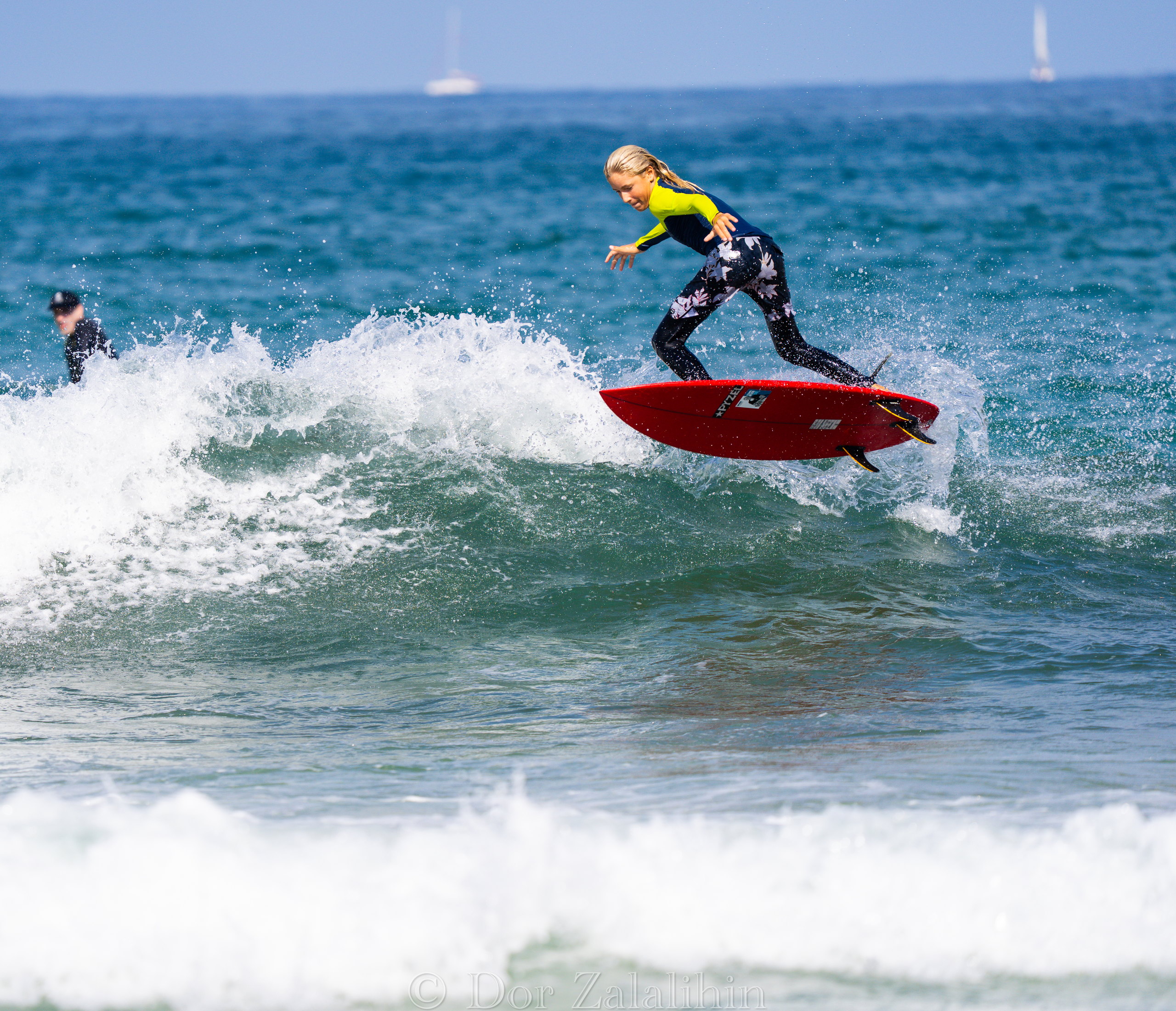 Surfer carving off the top of a wave